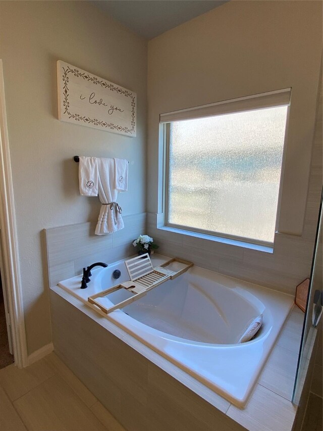 bathroom featuring a relaxing tiled tub