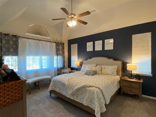 bedroom with lofted ceiling, ceiling fan, and carpet flooring