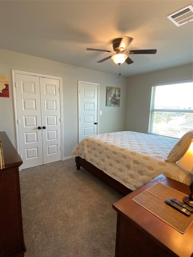 bedroom with ceiling fan and dark colored carpet