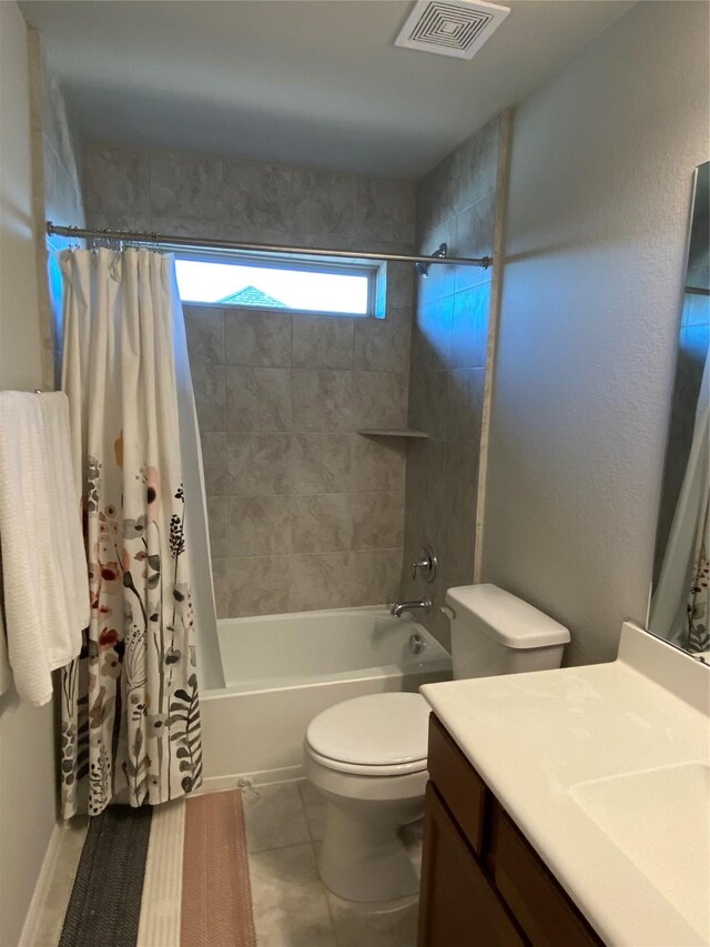 full bathroom with shower / bath combo, vanity, tile patterned floors, and toilet