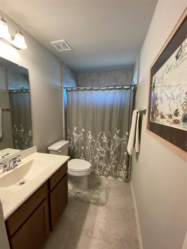 bathroom featuring vanity, curtained shower, and toilet