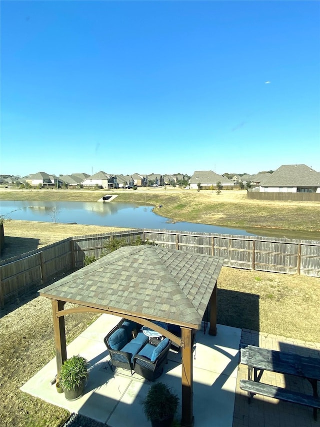 view of patio with a gazebo and a water view