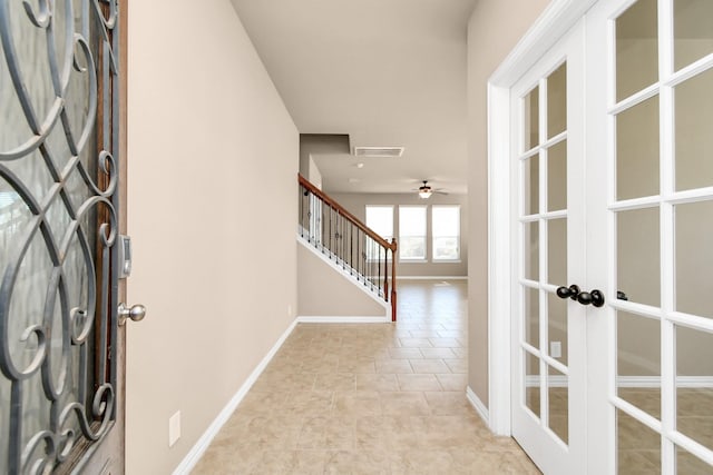 entryway with ceiling fan and french doors