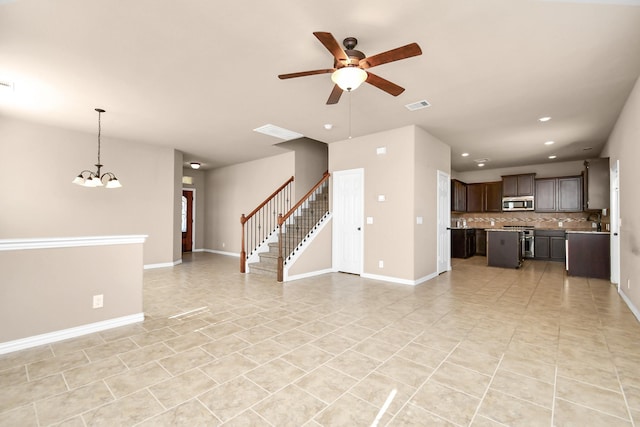 unfurnished living room with light tile patterned floors and ceiling fan with notable chandelier