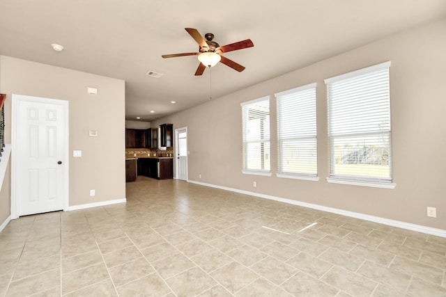 unfurnished living room with ceiling fan and light tile patterned flooring