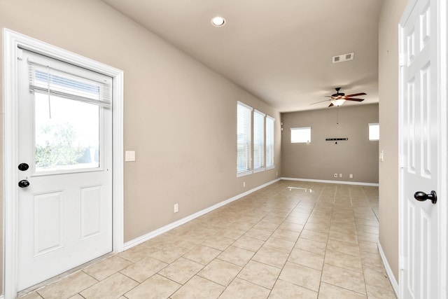 entryway featuring light tile patterned floors and ceiling fan