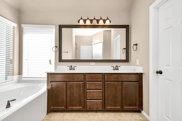 bathroom with vanity, a washtub, and tile patterned floors