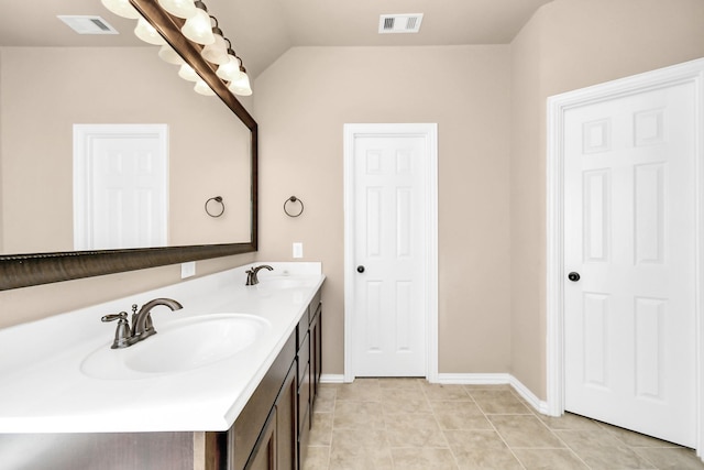 bathroom featuring vanity, vaulted ceiling, and tile patterned floors