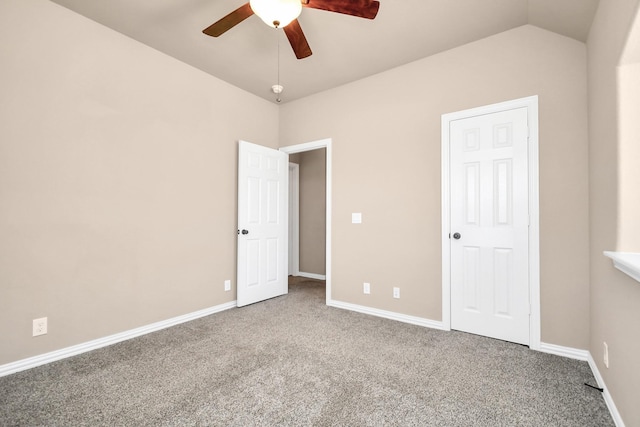 unfurnished bedroom featuring ceiling fan, lofted ceiling, and carpet