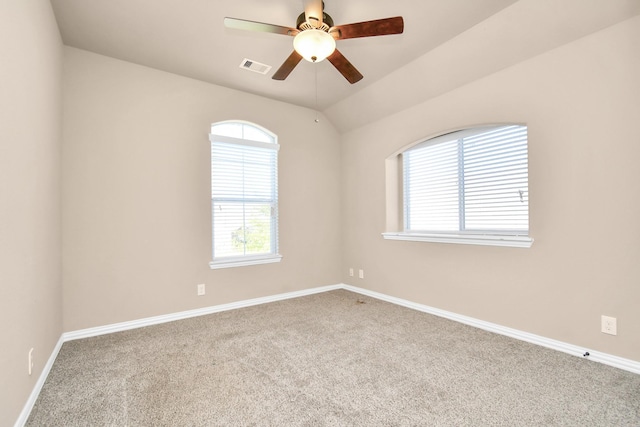 empty room with lofted ceiling, carpet, and ceiling fan