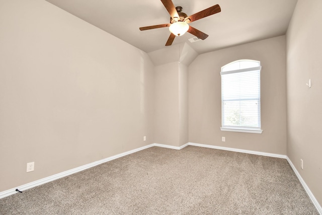 spare room with carpet floors, vaulted ceiling, and ceiling fan