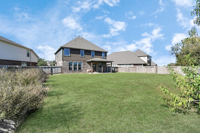 back of house featuring a lawn