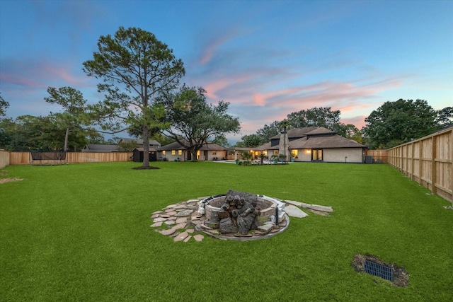 yard at dusk with an outdoor fire pit