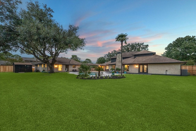 yard at dusk with a patio