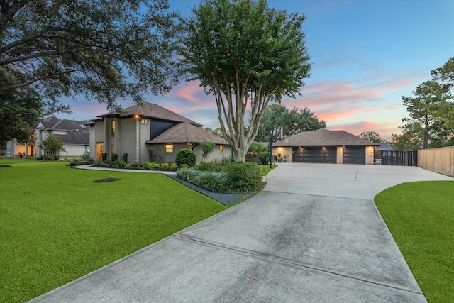 view of front of property with a garage and a yard