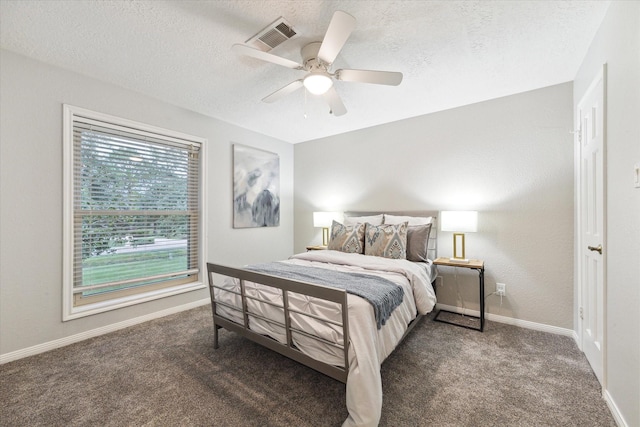 carpeted bedroom featuring a textured ceiling and ceiling fan