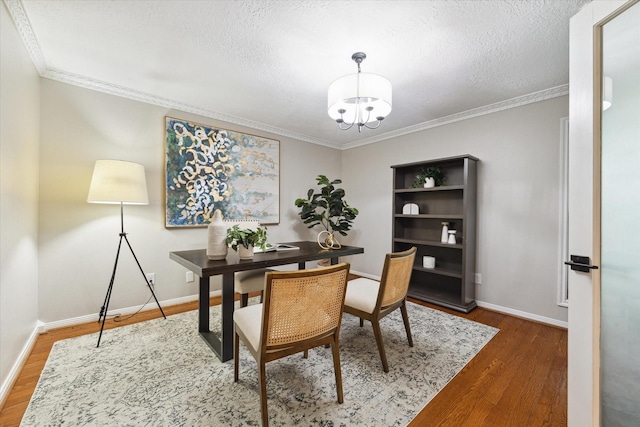 office area featuring dark wood-type flooring, ornamental molding, and a textured ceiling