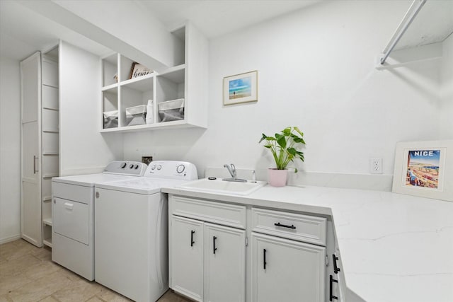 laundry room featuring separate washer and dryer, sink, and cabinets