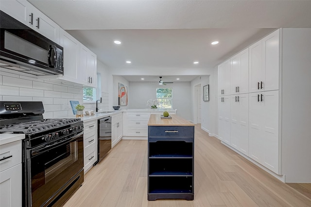 kitchen featuring white cabinetry and black appliances