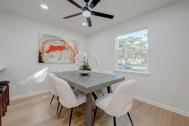 dining area with ceiling fan and light wood-type flooring