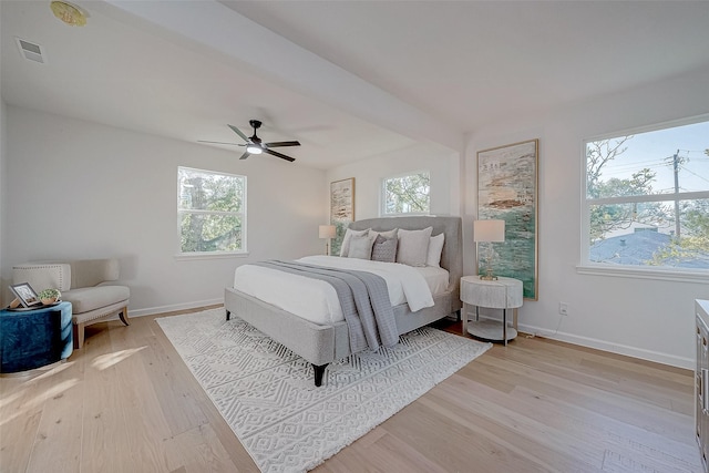 bedroom with multiple windows, ceiling fan, and light hardwood / wood-style flooring