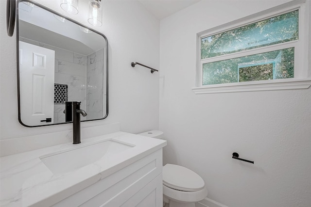 bathroom with vanity, walk in shower, and toilet