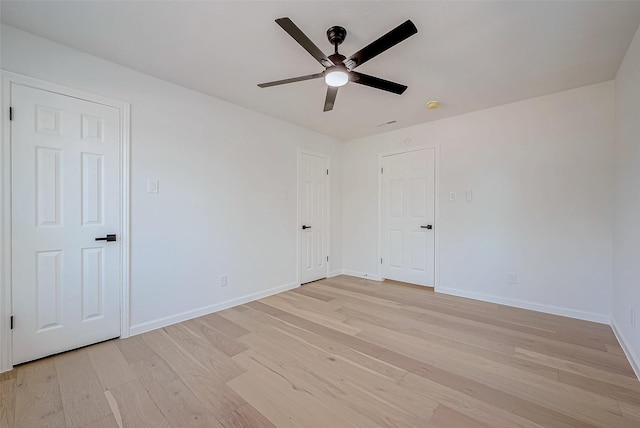 spare room with ceiling fan and light wood-type flooring