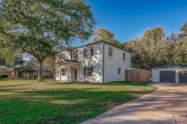 view of front facade with an outbuilding, a garage, and a front yard