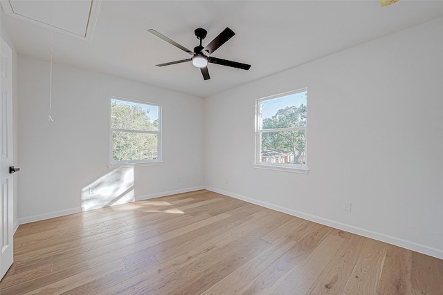 empty room featuring ceiling fan, a healthy amount of sunlight, and light hardwood / wood-style floors