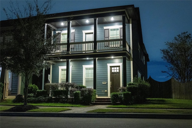 view of front of property featuring a balcony