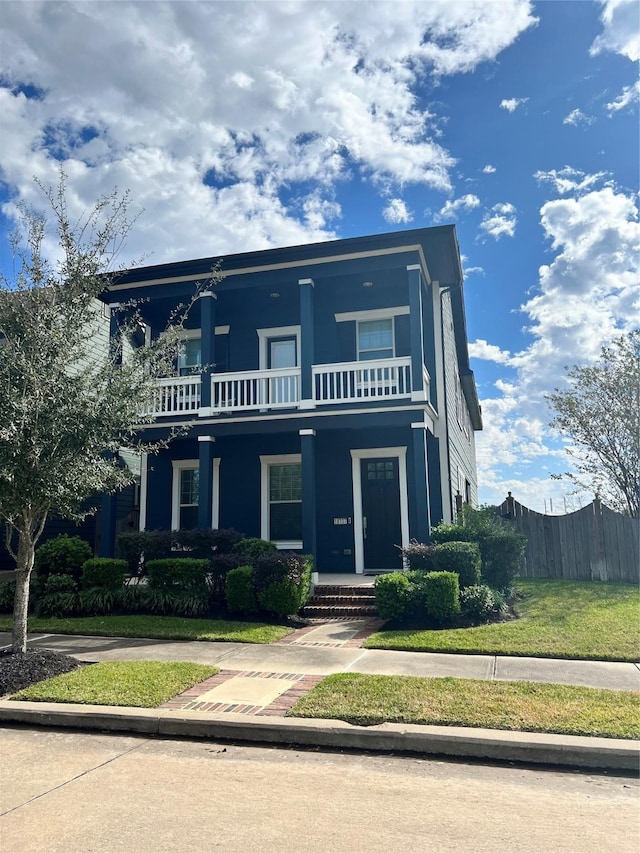 view of front of property with a balcony and covered porch