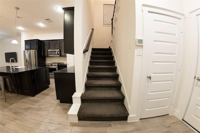 stairway featuring crown molding