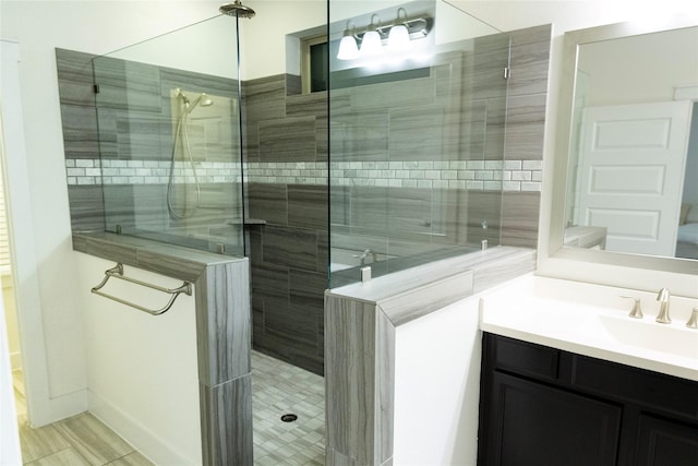 bathroom with vanity and a tile shower