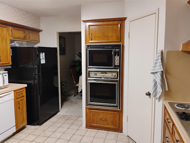 kitchen with light tile patterned floors and black appliances