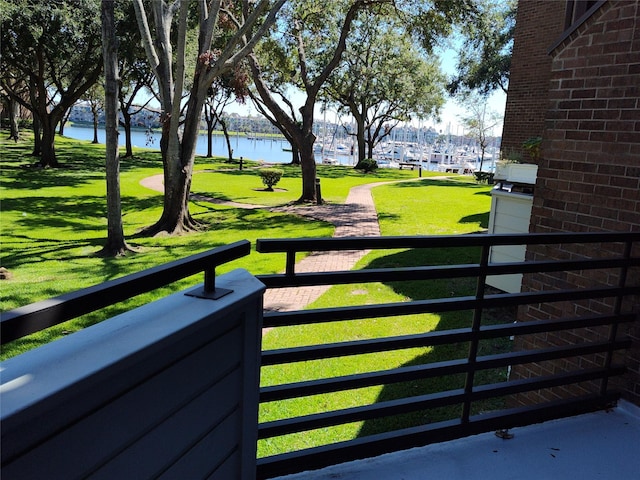 exterior space featuring a water view and a lawn