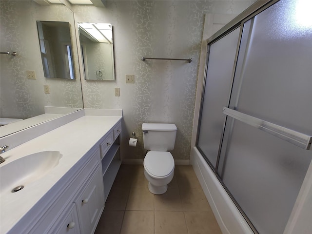 full bathroom featuring toilet, tile patterned floors, shower / bath combination with glass door, and vanity