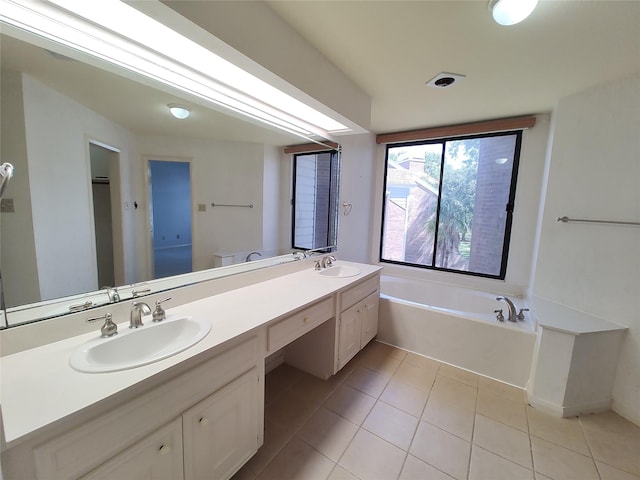 bathroom with vanity, toilet, tile patterned floors, and a tub to relax in