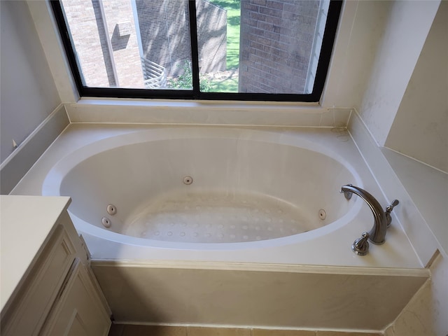 bathroom featuring vanity and a tub