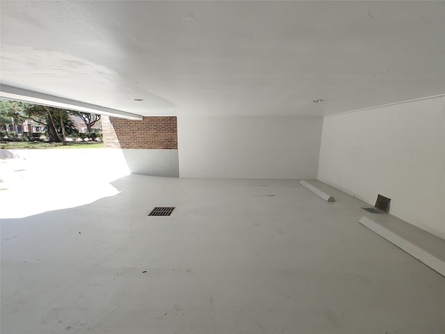 unfurnished room with concrete flooring