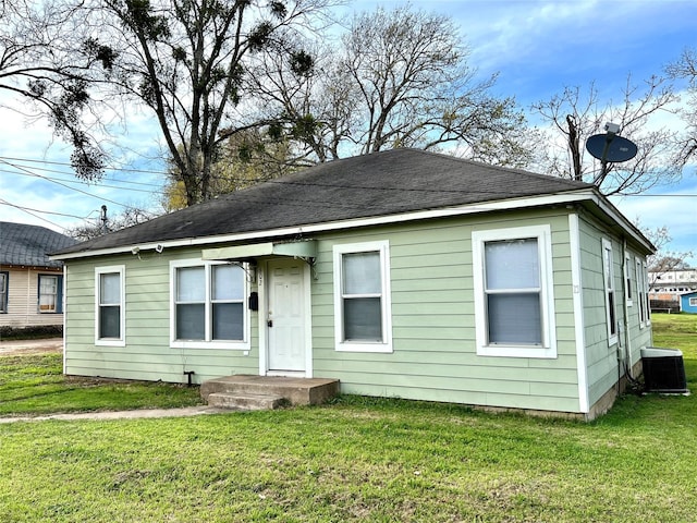 view of front facade with central AC and a front yard