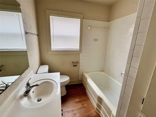 bathroom featuring sink, hardwood / wood-style flooring, plenty of natural light, and toilet