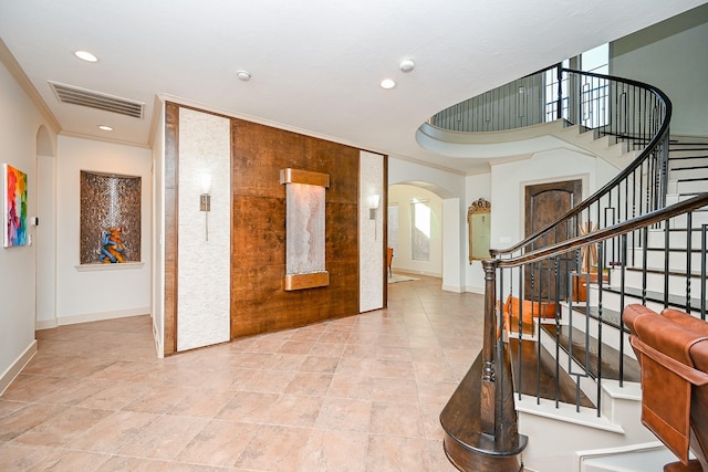 foyer entrance featuring crown molding