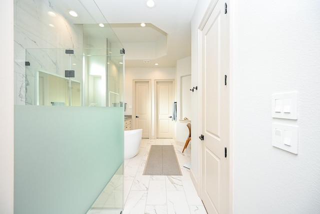 bathroom featuring vanity and independent shower and bath