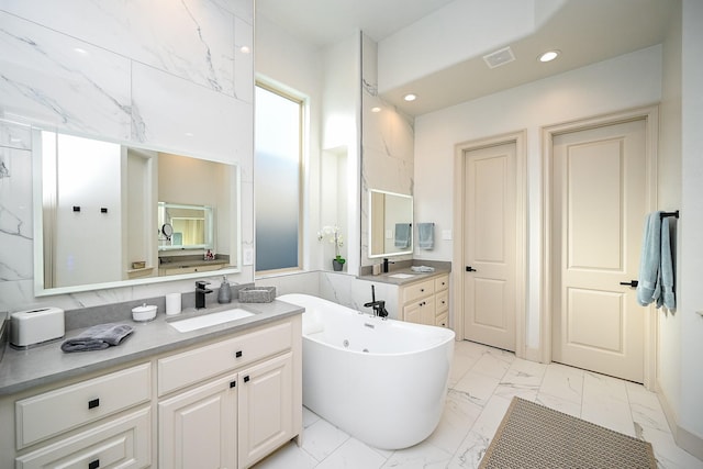 bathroom with vanity and a bathing tub