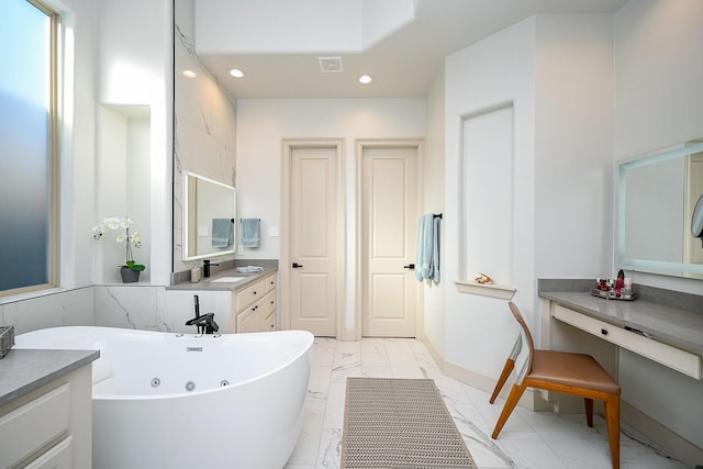 bathroom with vanity and a bathtub