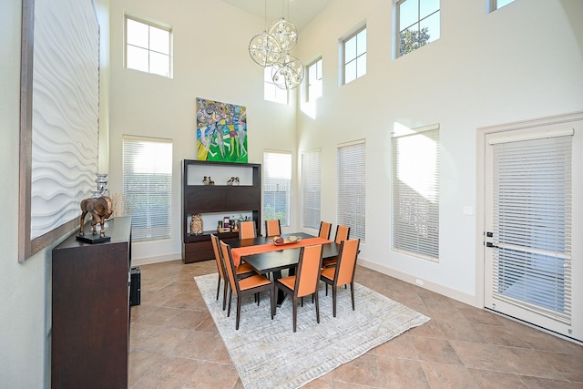 dining space featuring a chandelier and a high ceiling