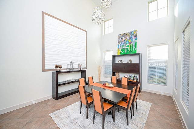 dining room featuring a high ceiling and a notable chandelier