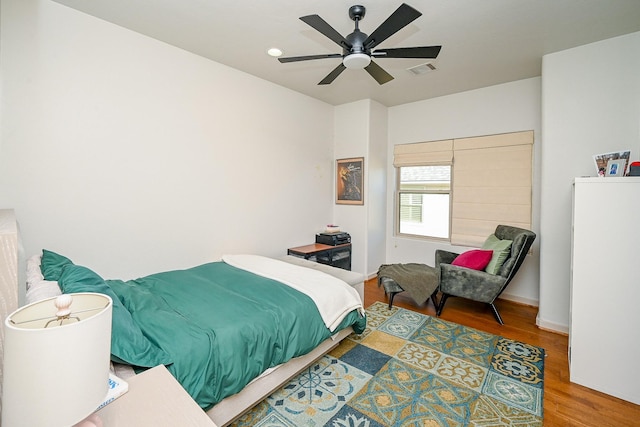 bedroom with ceiling fan and wood-type flooring