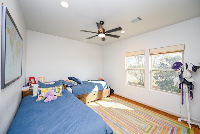 bedroom featuring hardwood / wood-style flooring and ceiling fan