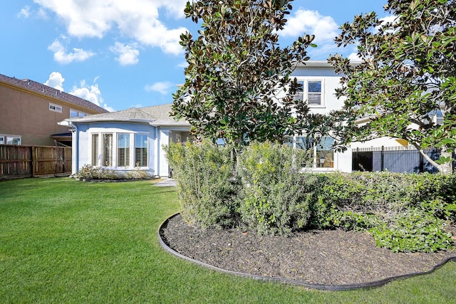 rear view of house with a yard